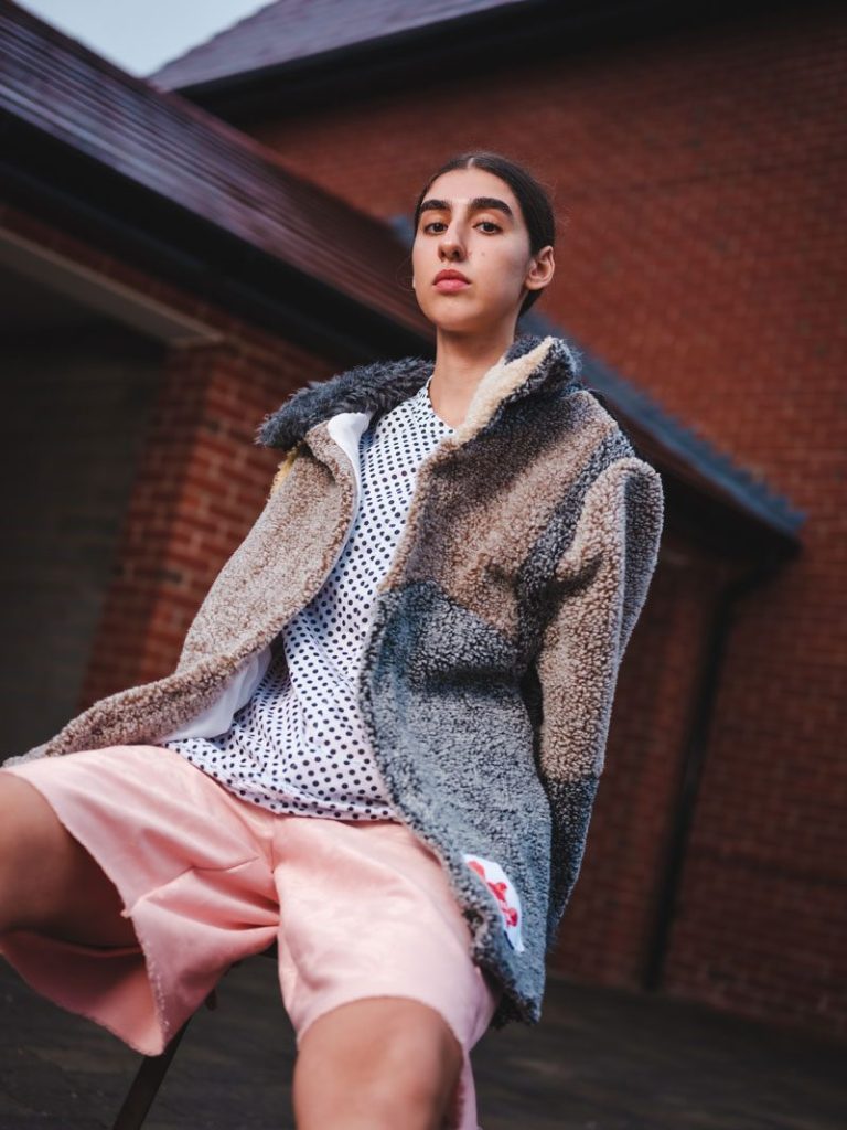 Lily from Crumb Agency wearing Oversized Teddy Bear coat in Pink with Pink Foral long boxing shorts and vintage reclaimed jersey polka dot tee. Image by Yousef Al Nasser