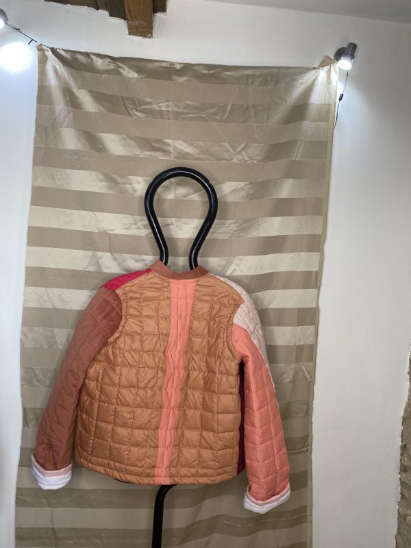 Back of pink quilted jacket made from upcycled remnant materials. Unisex and oversized jacket.
