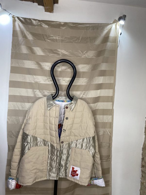 Front Photograph of the beige quilts jacket made from upcycled vintage remnant materials at The Silk Mill Studios in Frome