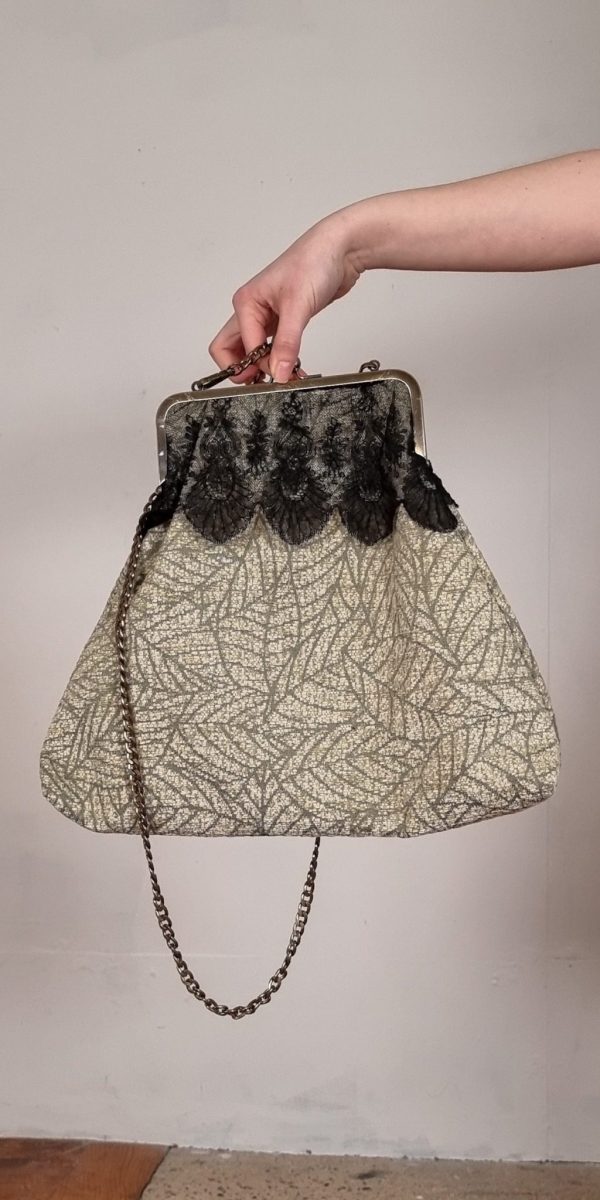 Frame Across the body vintage aesthetic clasp bag, with detachable antique chain strap. Made from Vintage Heavy Weight or Furnishing remnants, finished with vintage lace kindly donated by Gillian. The bag is fully lined with an inner zip pocket. Inspired by the renowned Mary Poppins bag.